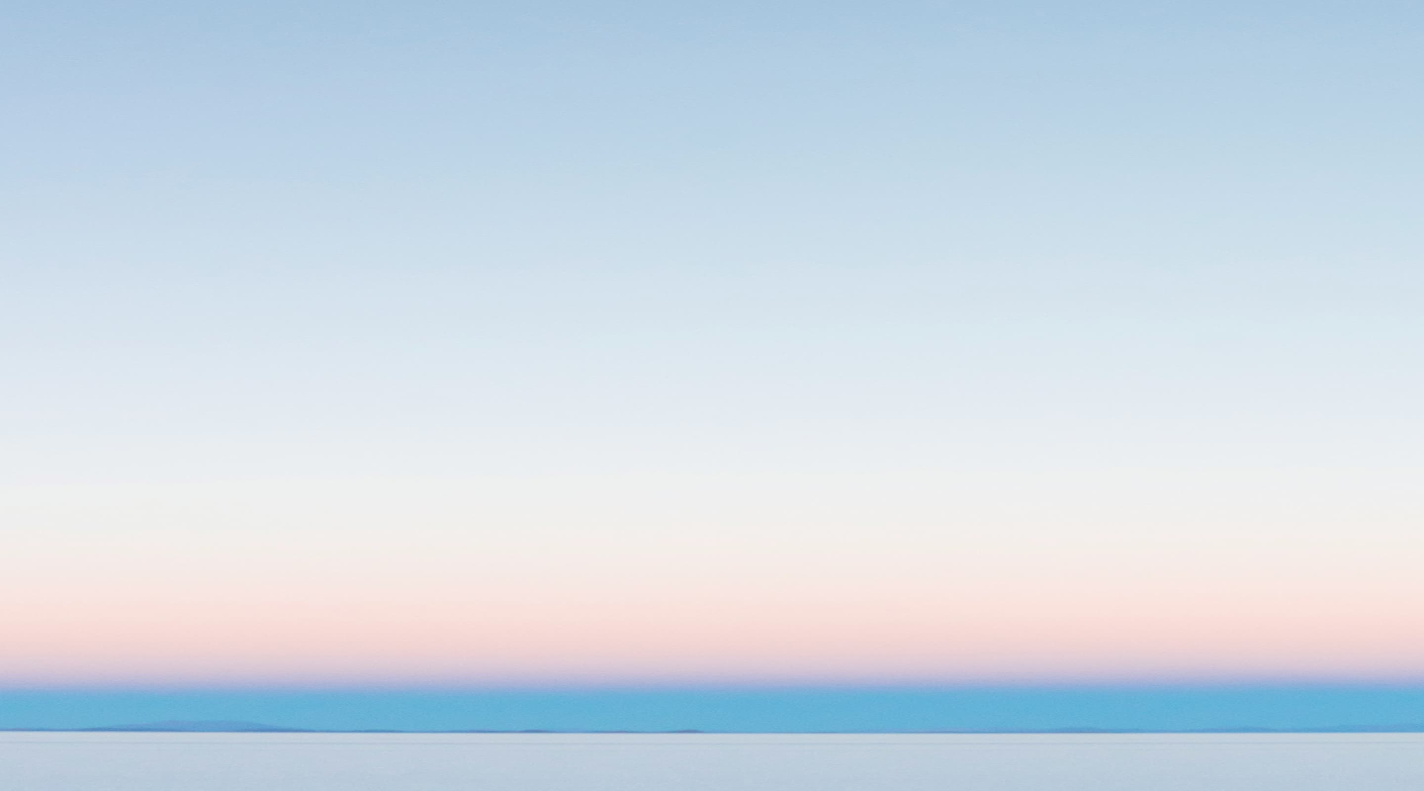 Traveller looking out of a plane window at sunset
